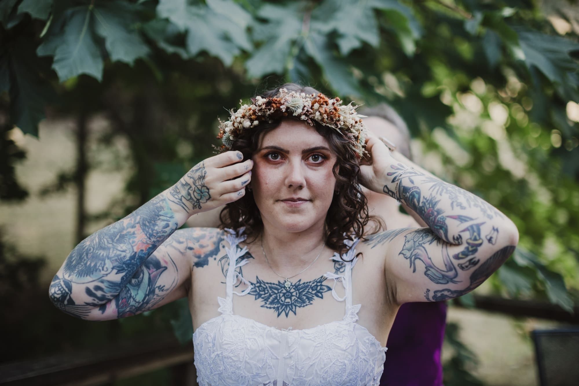 Bride adjusting her flower crown while getting ready
