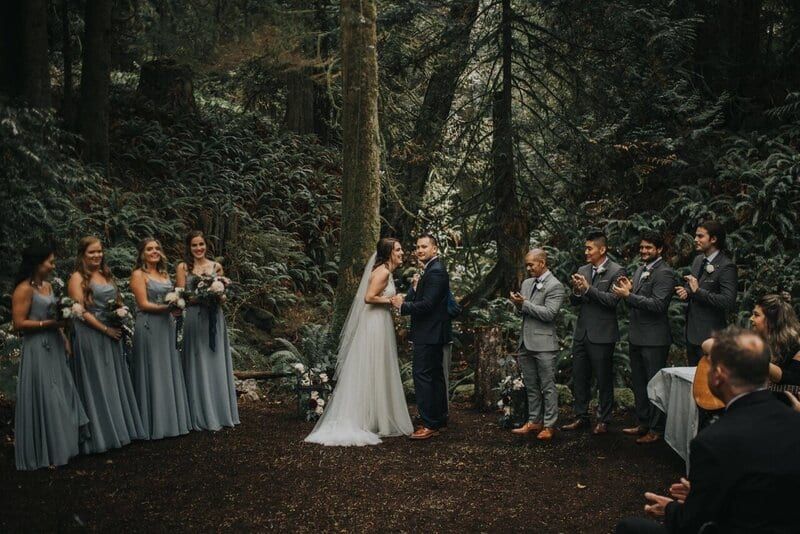 Forest ceremony beneath mossy firs at Cedar Haven Weddings