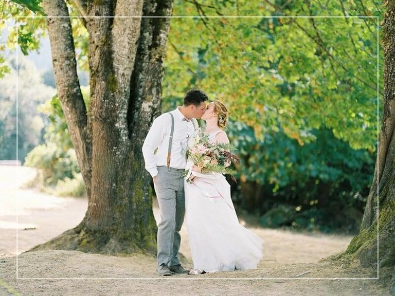 Couple kissing beneath old maples at Mary's Farm & Sanctuary
