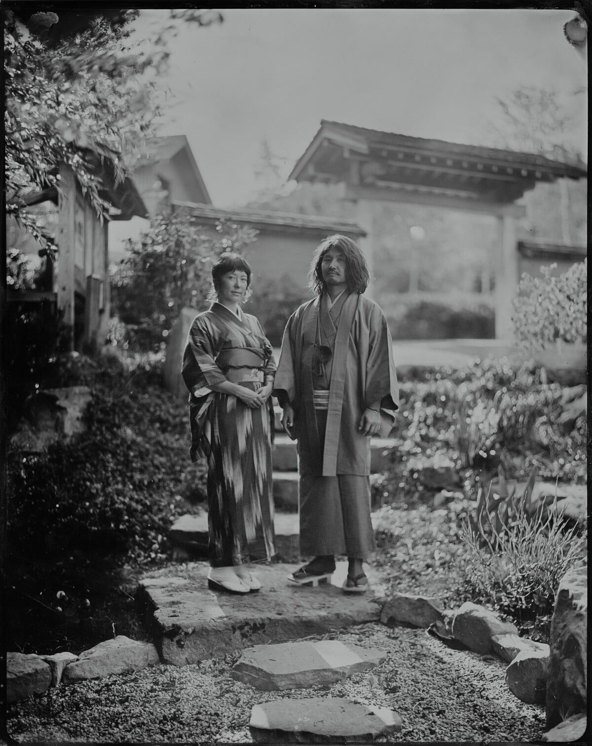 Couple wearing kimono in a Japanese garden, tintype