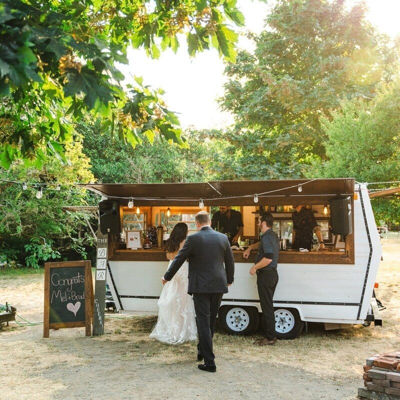 Newlyweds ordering drinks at the TravelBar vintage trailer bar