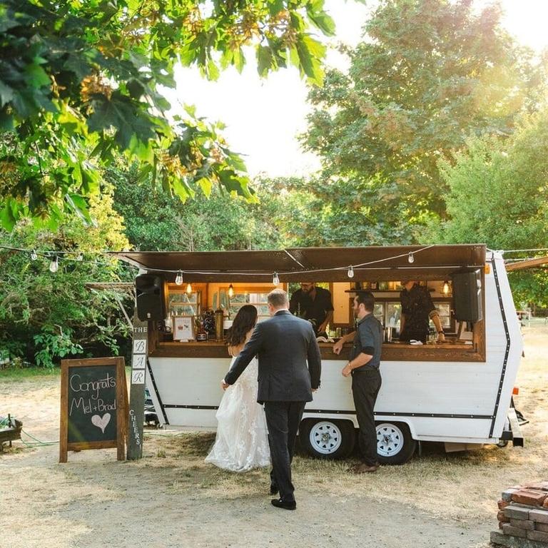 Newlyweds ordering drinks at the TravelBar vintage trailer bar