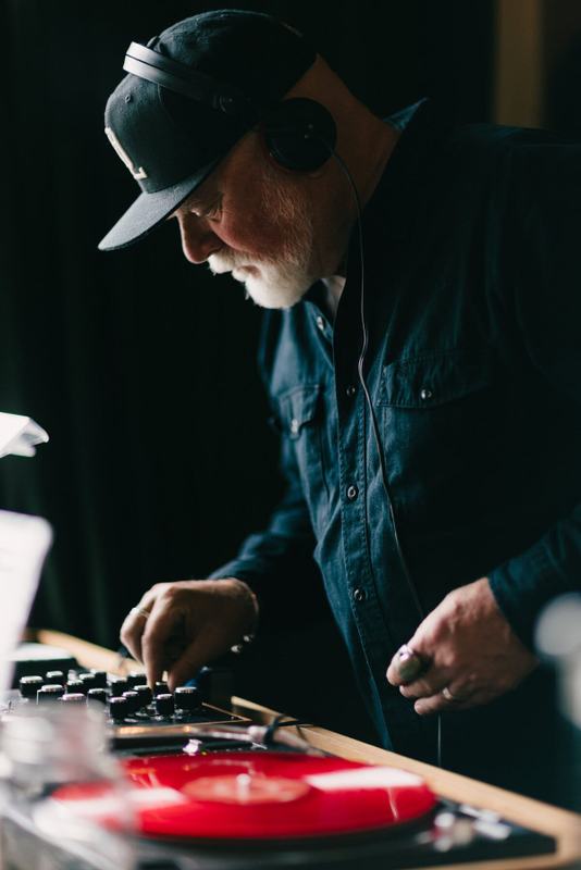 Hands at the controls as a red record spins