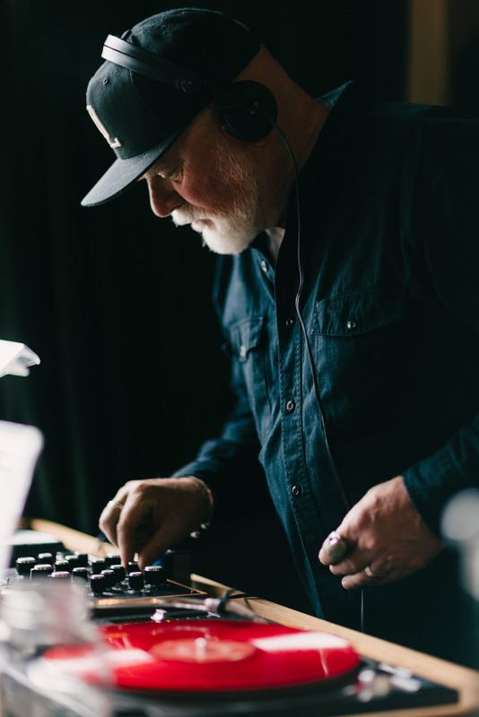 Hands at the controls as a red record spins