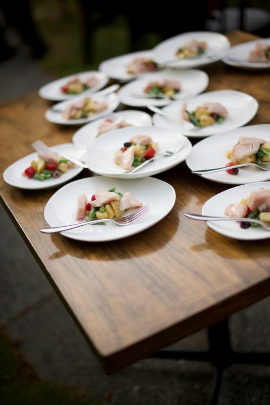 Plated appetizers arranged across a wooden harvest table