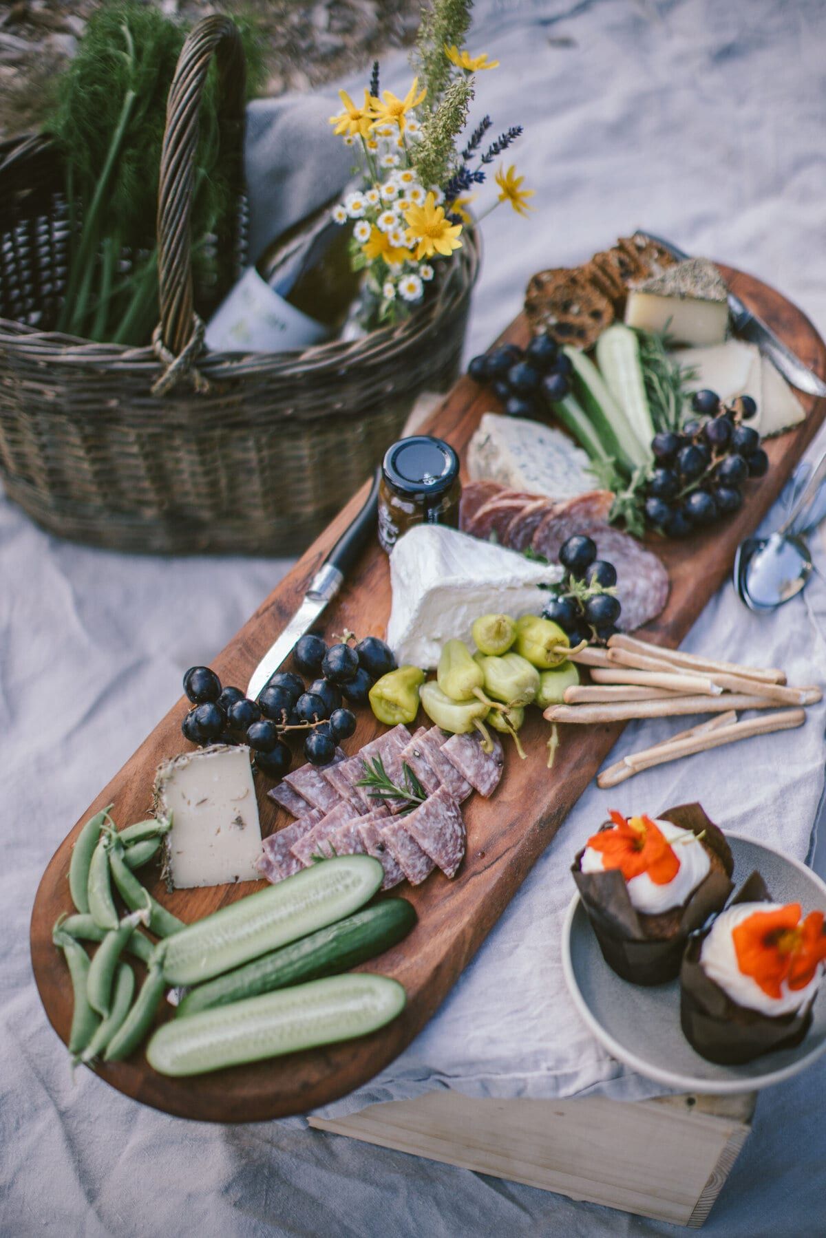 Farm charcuterie board with grapes, cheese and fresh vegetables