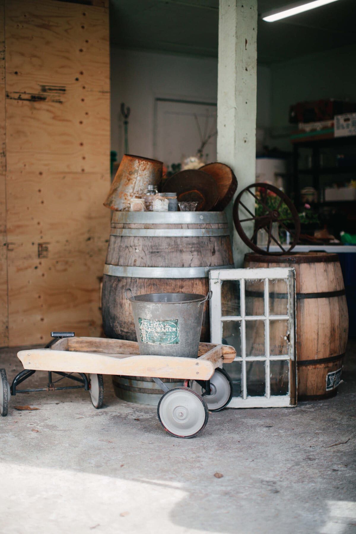 Wine barrels, wagon and salvaged window in the rental workshop