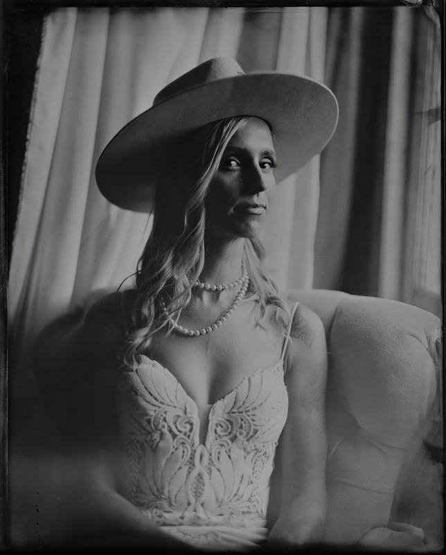 Bride in a wide-brimmed hat and pearls, tintype portrait