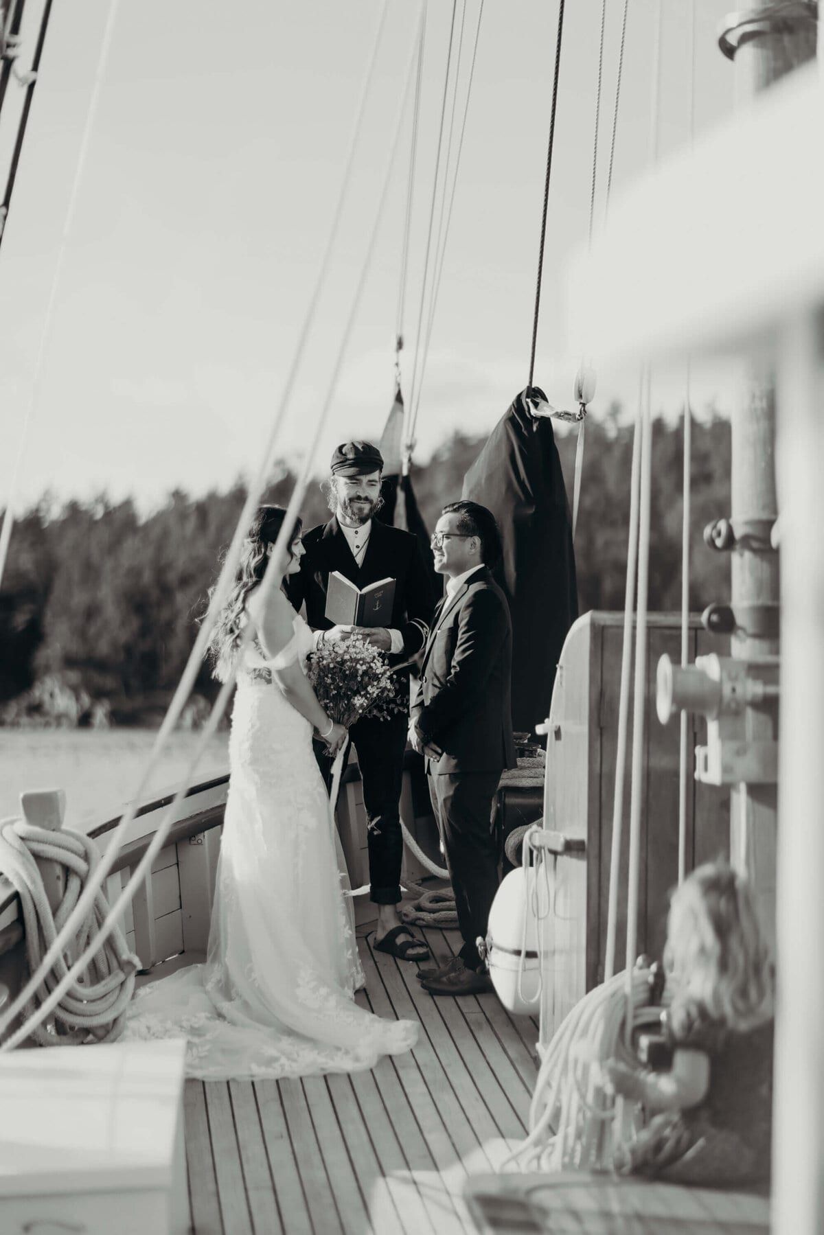 Shipboard wedding ceremony with a young guest watching from the deck