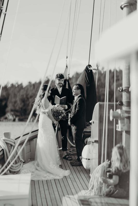 Shipboard wedding ceremony with a young guest watching from the deck