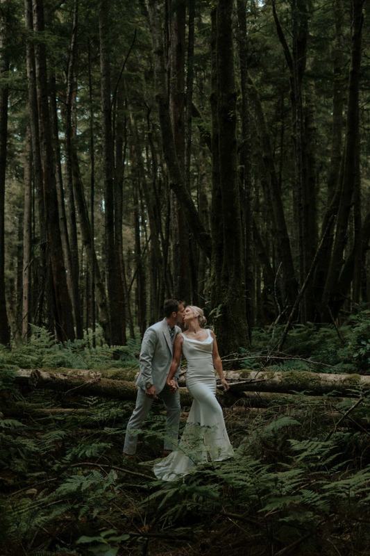 Couple embracing among ferns in an old-growth forest