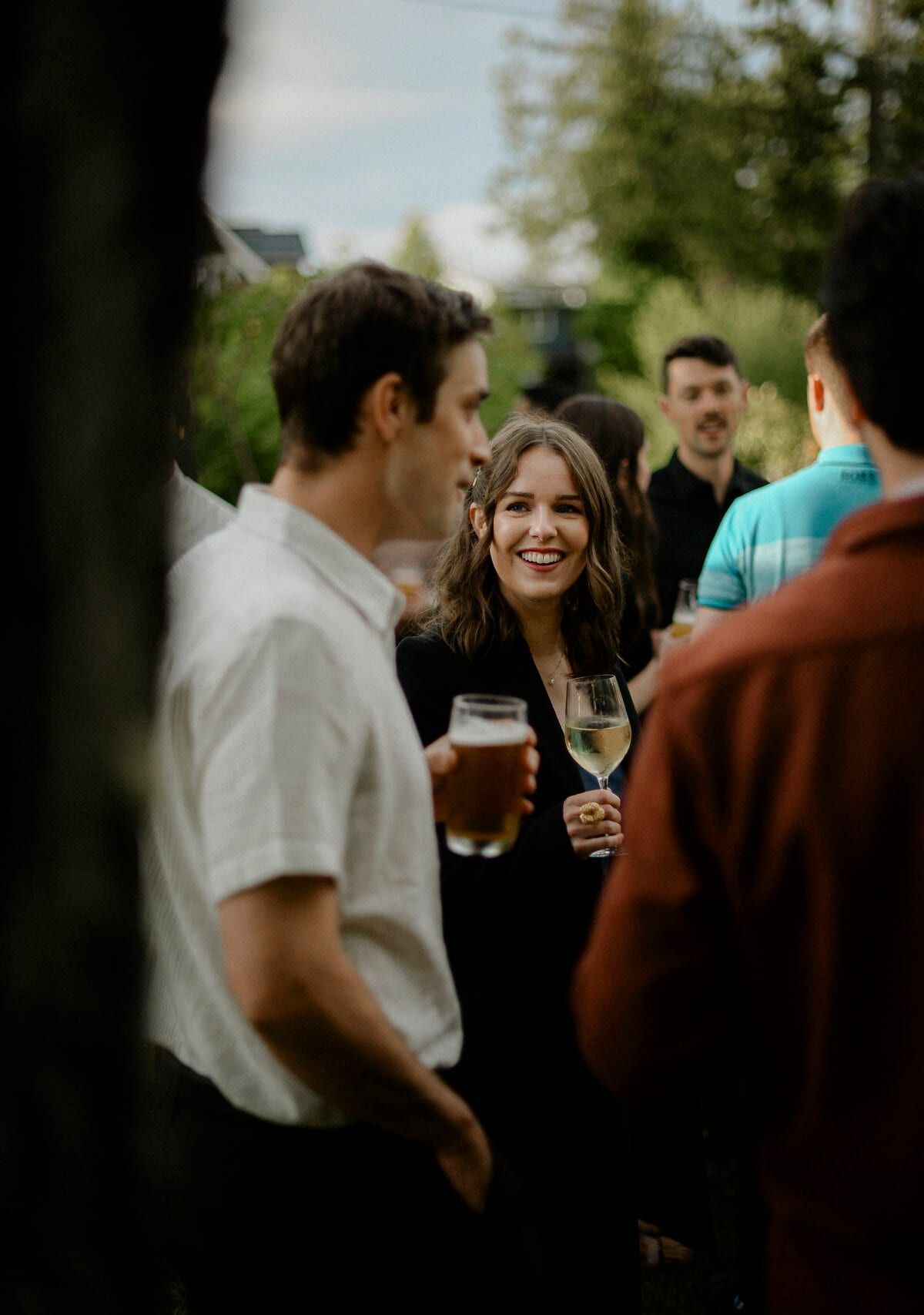 Guests chatting over beer and wine at an outdoor reception