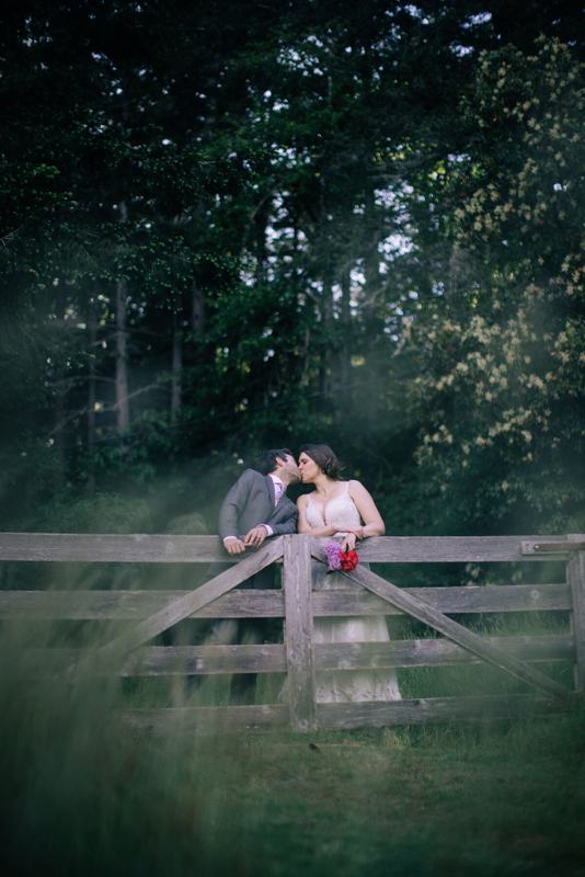 Kiss at the farm gate as evening settles over the forest