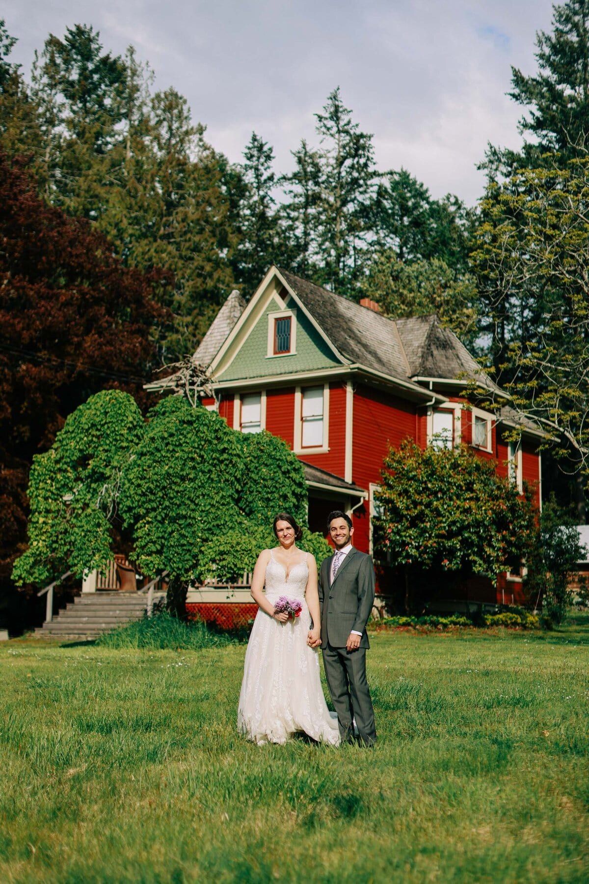 Bride and groom on the lawn of Ruckle Farm's Victorian farmhouse