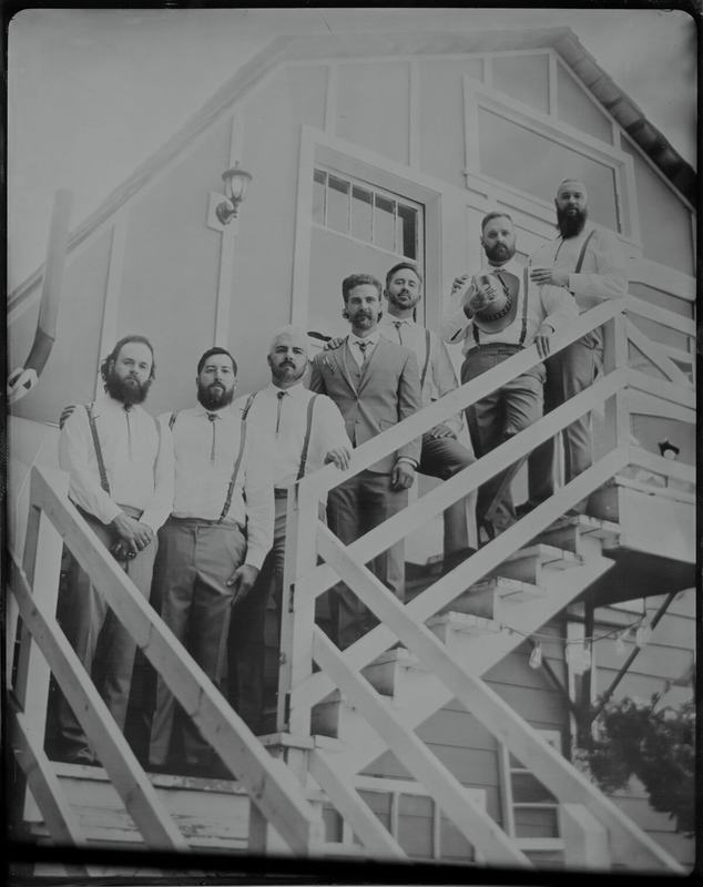 Groomsmen gathered on an outdoor staircase, wet-plate group shot