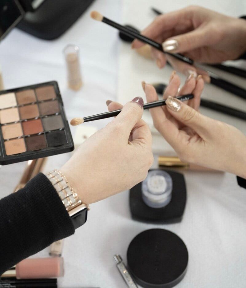 Trish Monkhouse's hands at work with palette and brushes