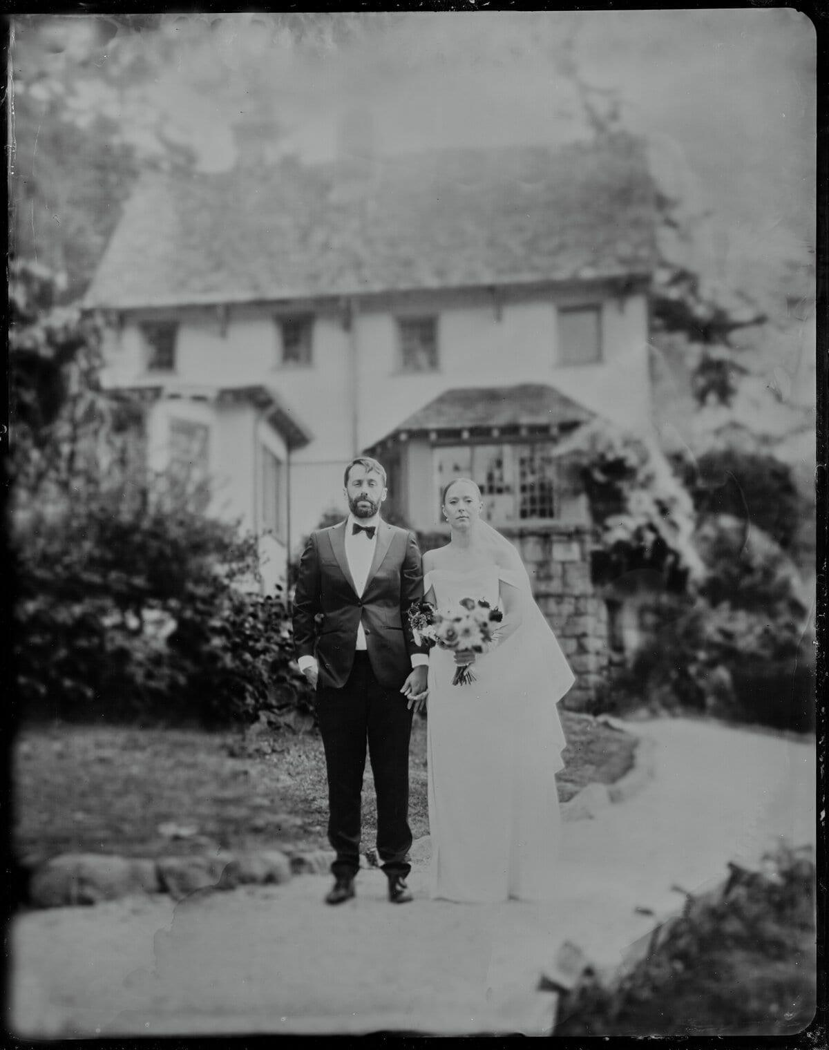 Bride and groom walk arm-in-arm toward camera at Hastings House on Salt Spring Island